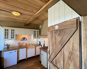 Cozy kitchen in Holiday home in Markelo, Twente. Wooden elements and modern amenities in a cozy vacation home in Overijssel.