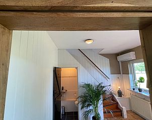 Interior of Holiday Home in Markelo, Twente, Overijssel with modern furnishings and stairs to upper floor.