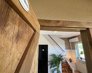 Cozy indoor area of Holiday home in Markelo, Twente, with wooden door and cozy interior in Overijssel.