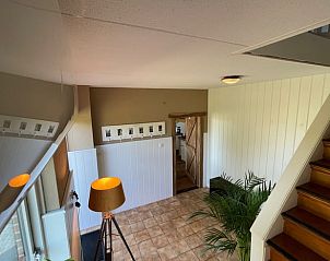 Entrance to Holiday home in Markelo, located in beautiful Twente, Overijssel. Cozy indoor area with wooden staircase and modern furnishings.