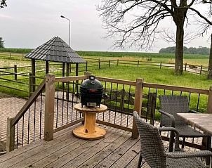 View of the green surroundings from the terrace of Holiday home in Markelo, Twente, Overijssel with comfortable seating.