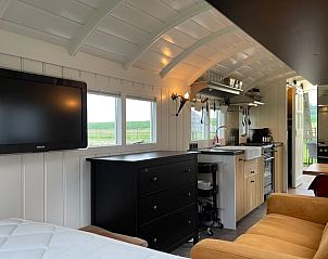 Spacious interior of Holiday Home in Markelo, Twente, Overijssel with modern amenities and TV.