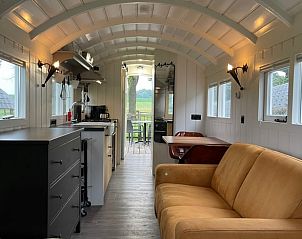 Cozy living room in Holiday home in Markelo, Twente, Overijssel overlooking the green landscape.