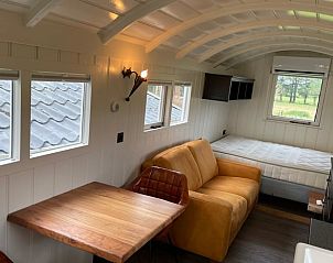Rustic dining area in Holiday home in Markelo, Twente, Overijssel overlooking the green surroundings.