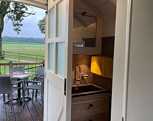 Bathroom in Holiday cottage in Markelo, Twente, Overijssel with modern sink and terrace view.