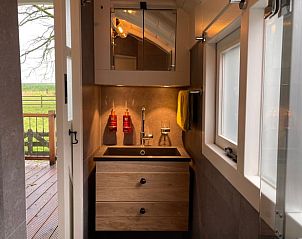 Compact bathroom in Holiday Home in Markelo, Twente, Overijssel with stylish sink and mirror.