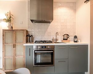 Dining area in Holiday home in Usselo, Twente, with access to the bedroom and view of the terrace.