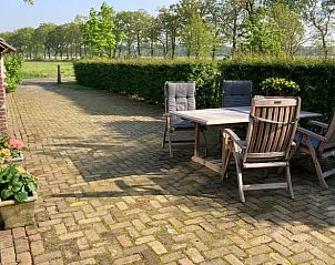 Ruim terras van vakantiehuis in Hellendoorn met uitzicht op de groene omgeving van Salland, Overijssel.