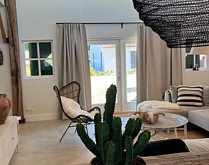 Cozy living room in Holiday home in Ommen, Vechtstreek, Overijssel with modern interior and garden view.