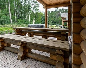 Wooden picnic tables on the terrace of Holiday home in Ommen, located in the Vecht region, Overijssel.