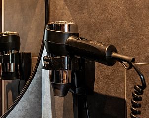 Hair dryer in the bathroom of Holiday home in Ommen, a comfortable stay in the Vecht region, Overijssel.