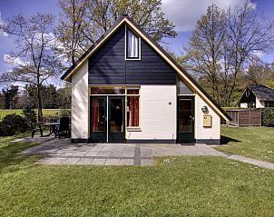 Charmante voorzijde van Vakantiehuis Buitenplaats Gerner in Dalfsen, omgeven door groene natuur.
