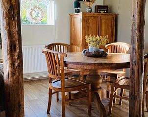 Eettafel in Huisje in Balkbrug, vakantiehuis in Vechtstreek, Overijssel, omgeven door houten balken en decoraties.