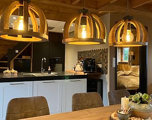 Cozy indoor area of Holiday Home in Giethmen, Overijssel, with atmospheric lighting and modern kitchen.