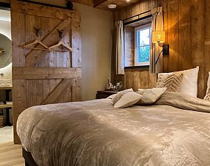 Attractive bedroom in Holiday cottage in Giethmen, Vechtstreek, Overijssel with wooden interior and comfortable beds.