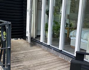 Veranda van Vakantiehuisje in Tuk met toegang tot de slaapkamer, gelegen in Noordwest Overijssel.