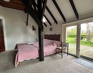 Slaapkamer in Vakantiehuis in Eesveen in Noordwest-Overijssel met terras en tuinzicht.