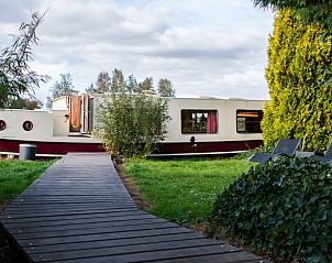 Toegangspad naar Huisje in Vinkeveen, vakantiehuis in Utrecht noord, Utrecht omringd door groen.