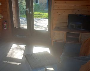 Bright living room with access to garden in Holiday home in Wissenkerke, North Beveland, ideal for relaxation.