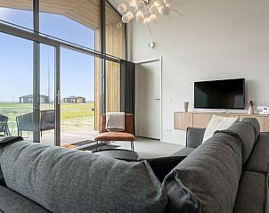 Cozy living room with modern furnishings in Cottage in Wissenkerke, Zeeland.