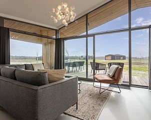 Bright living room with many windows in Cottage in Wissenkerke, North Beveland.