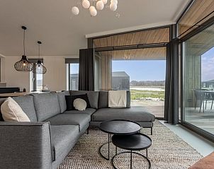 Modern seating area in Cottage in Wissenkerke overlooking the terrace in Zeeland.