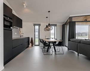 Open kitchen and living area in Cottage in Wissenkerke, Zeeland with modern furnishings.