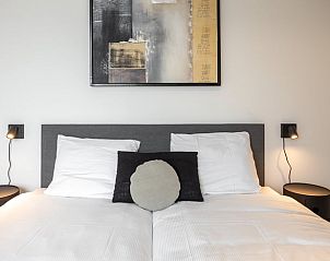 Comfortable bedroom with art on the wall in Cottage in Wissenkerke, North Beveland.