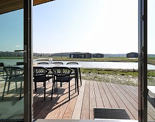 Sunny terrace at Huisje in Wissenkerke, a vacation home in Wissenkerke, North Beveland, Zeeland.