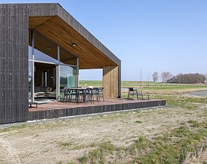 Terrace with nature view at Huisje in Wissenkerke, a vacation home in Wissenkerke, North Beveland, Zeeland.