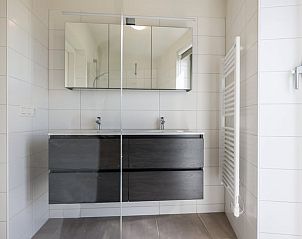 Stylish bathroom in Holiday home in Wissenkerke, Noord-Beveland, Zeeland with double sink.