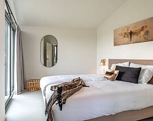 Bright bedroom in Holiday home in Wissenkerke, Noord-Beveland, Zeeland with mirror.