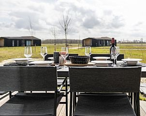 Cozy dining table on the terrace of Holiday Home in Wissenkerke, overlooking North Beveland, Zeeland.