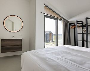 Luxury bedroom in Holiday home in Wissenkerke with modern decor in North Beveland, Zeeland.