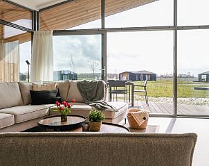 Sunny living room in Holiday home in Wissenkerke overlooking the surroundings of North Beveland, Zeeland.