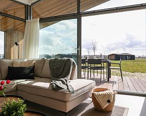 Bright living room in Holiday home in Wissenkerke with comfortable seating area in Noord-Beveland, Zeeland.