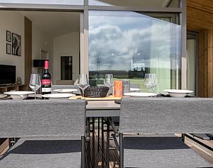 Dining table on the terrace of cottage in Wissenkerke overlooking North Beveland, Zeeland.