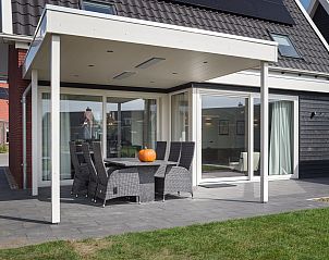berdachte Terrasse des Ferienhauses Ganuenta, Colijnsplaat, Noord-Beveland mit Gartenmbeln fr Mahlzeiten im Freien.