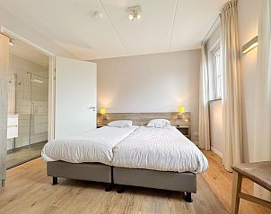 Hoofdslaapkamer in Villa Superieur 64, Colijnsplaat, met tweepersoonsbed en en-suite badkamer in Zeeland.