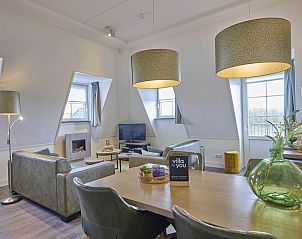 Gezellige woonkamer van Sauna Zee 27H vakantiehuis in Colijnsplaat, Noord-Beveland, met moderne inrichting en veel natuurlijk licht.