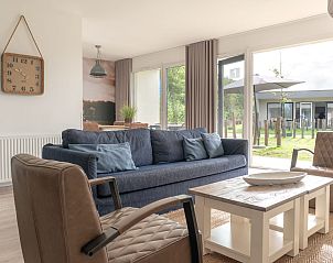 Gemtliches Wohnzimmer von Bungalow de Boei mit Blick auf den Garten in Kamperland, Noord-Beveland, Zeeland.