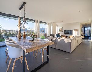 Gezellige zithoek in Duinvallei 39, De Groote Duynen, Kamperland, met comfortabele banken en een open haard.