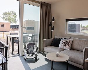 Cozy indoor area of Baby Lodge 2+1 in Kamperland, North Beveland, with comfortable sitting area and terrace view.