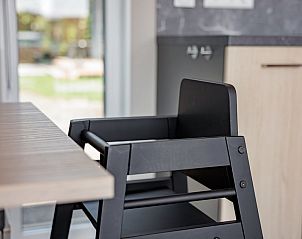 Cozy bedroom in Baby Lodge 2+1, a vacation home in Kamperland, North Beveland, Zeeland, overlooking the green surroundings.