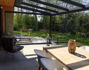 Binnenruimte van Populierenlaan 1 | Ruiterplaat, vakantiehuis in Kamperland, met comfortabele stoelen en tuinzicht.