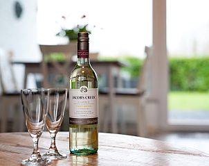 Eine Flasche Wein auf dem Tisch im Ferienhaus Patrijzenlaan 5, De Banjaard, Kamperland.