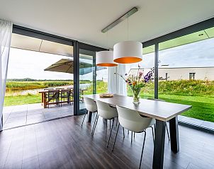 Eethoek met bloemen in Waterlijn 42 | De Groote Duynen, Kamperland, vakantiehuis met uitzicht op de tuin in Noord-Beveland, Zeeland.