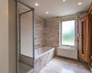 Luxurises Badezimmer mit Badewanne und Dusche in VZ1170 Ferienbungalow in Kamperland, fr ultimative Entspannung in Noord-Beveland, Zeeland.