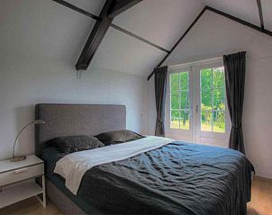 Geniet van ontspanning op het terras van vakantiehuis ZE947 in Kamperland, Noord-Beveland, met comfortabele zitplaatsen en een fles wijn.