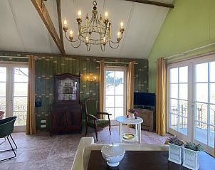 Bright living room in VZ962 Holiday home in Kamperland, with chandelier and antique cabinet in North Beveland, Zeeland.